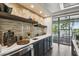 Modern bar area featuring sleek countertops, custom shelving, and view to the lake at 9080 Morgana Ct, Winter Garden, FL 34787