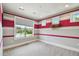 Bedroom with colorful striped walls and carpet flooring with multiple windows at 9080 Morgana Ct, Winter Garden, FL 34787