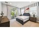 Cozy bedroom featuring neutral walls, carpeted floors, and a private screened balcony at 9080 Morgana Ct, Winter Garden, FL 34787