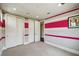 Bedroom with grey and pink striped walls, carpet, closet and trim at 9080 Morgana Ct, Winter Garden, FL 34787