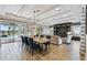 Bright dining area with lake views, an elegant table, and seamless access to an outdoor pool area at 9080 Morgana Ct, Winter Garden, FL 34787
