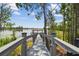Picturesque wooden dock with a covered pier stretching out into a serene lake surrounded by lush greenery at 9080 Morgana Ct, Winter Garden, FL 34787