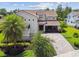 Stunning two-story home with well-manicured landscaping, a brick driveway, and a welcoming front porch at 9080 Morgana Ct, Winter Garden, FL 34787