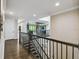 Second floor hallway with hardwood floors and wrought iron banister at 9080 Morgana Ct, Winter Garden, FL 34787