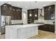 Gourmet kitchen featuring dark wood cabinets, stainless steel appliances, and a large center island at 9080 Morgana Ct, Winter Garden, FL 34787