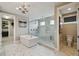 Luxury main bathroom featuring marble floors, soaking tub, and frameless shower with body sprays at 9080 Morgana Ct, Winter Garden, FL 34787