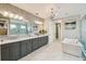 Elegant main bathroom with dual vanity, soaking tub, and a glass enclosed shower at 9080 Morgana Ct, Winter Garden, FL 34787