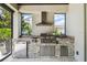 Outdoor kitchen with stainless steel grill, mini fridge, and countertop at 9080 Morgana Ct, Winter Garden, FL 34787