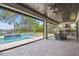 Outdoor patio featuring a pool, hot tub, grill and covered dining area at 9080 Morgana Ct, Winter Garden, FL 34787