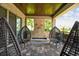Covered patio with stone accents, featuring a water feature and stylish egg chairs for outdoor relaxation at 9080 Morgana Ct, Winter Garden, FL 34787