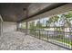 Spacious screened patio boasts serene lake views, brick floors, and tongue and groove ceiling at 9080 Morgana Ct, Winter Garden, FL 34787