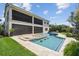 Luxury pool with swim-up bar, sun shelves, and water features enhances the backyard of this beautiful home at 9080 Morgana Ct, Winter Garden, FL 34787