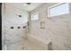 Frameless marble shower with built-in bench, multiple shower heads, and recessed niche at 9080 Morgana Ct, Winter Garden, FL 34787