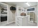 Organized walk-in closet featuring custom shelving, drawers, and an island with additional storage at 9080 Morgana Ct, Winter Garden, FL 34787