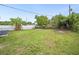 Spacious backyard featuring a lush lawn, mature trees, and a white privacy fence at 1022 Baycrest Dr, Lakeland, FL 33805