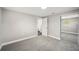 Cozy carpeted bedroom with open door to bathroom and mirrored closet at 1022 Baycrest Dr, Lakeland, FL 33805