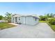 Charming home featuring a light blue exterior, simple landscaping, and a large driveway at 1022 Baycrest Dr, Lakeland, FL 33805