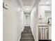 Bright hallway with wood-look flooring leads to modern kitchen with stainless steel appliances at 1022 Baycrest Dr, Lakeland, FL 33805