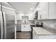 This modern kitchen is updated with stainless steel appliances, granite countertops and modern white cabinetry at 1022 Baycrest Dr, Lakeland, FL 33805