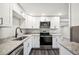 Modern kitchen with stainless steel appliances, granite countertops and stylish black fixtures at 1022 Baycrest Dr, Lakeland, FL 33805