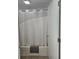 Bright bathroom with a shower-tub combination, featuring a white shower curtain at 7601 Canada Ave # 220, Orlando, FL 32819