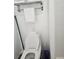 Toilet with white seat up next to bathroom wall with toilet paper holder and cleaning supplies at 7601 Canada Ave # 220, Orlando, FL 32819