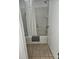 Cozy bathroom featuring a tiled shower/tub combination with a white shower curtain and ceramic floors at 7601 Canada Ave # 220, Orlando, FL 32819