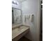 Bathroom with sink, mirror and towel rack with towels at 7601 Canada Ave # 220, Orlando, FL 32819