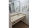 Clean bathroom features a modern vanity with a sleek countertop and ample towel storage at 7601 Canada Ave # 220, Orlando, FL 32819
