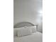 Bright bedroom featuring a neutral color scheme, comfortable bedding, and a decorative headboard at 7601 Canada Ave # 220, Orlando, FL 32819