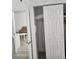 Organized closet space featuring shelving, ironing board, and ample storage at 7601 Canada Ave # 220, Orlando, FL 32819