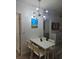 Bright dining area features a modern white table and chairs set, complemented by playful wall art at 7601 Canada Ave # 220, Orlando, FL 32819