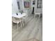 Bright dining area with a white table, four chairs, and a modern entertainment center at 7601 Canada Ave # 220, Orlando, FL 32819