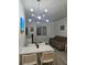 Bright living space featuring modern lighting, a comfortable sofa, dining table, and a window at 7601 Canada Ave # 220, Orlando, FL 32819