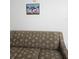 Cozy living room featuring a patterned sofa and a framed Sonic artwork on the wall at 7601 Canada Ave # 220, Orlando, FL 32819