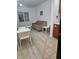 Cozy living area featuring wood floors, a decorative sofa, and dining space near the kitchen at 7601 Canada Ave # 220, Orlando, FL 32819
