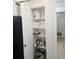 Pantry with shelves, towels, dinnerware, and essential supplies neatly organized at 7601 Canada Ave # 220, Orlando, FL 32819