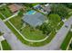 Gorgeous aerial view of home with beautiful lawn, swimming pool, and mature trees at 107 Elm N Sq, Lakeland, FL 33813