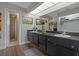 Bathroom featuring a double vanity, skylight, and walk-in shower at 107 Elm N Sq, Lakeland, FL 33813