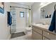 Bright bathroom with a shower-tub combo, neutral vanity, and a window at 107 Elm N Sq, Lakeland, FL 33813