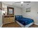 Comfortable bedroom with wood-look floors, a nautical painting, and a large mirror at 107 Elm N Sq, Lakeland, FL 33813