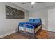 Bedroom with wood-look floors, decorative headboard and area rug at 107 Elm N Sq, Lakeland, FL 33813