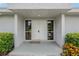 Close up of the home's front entrance with double doors and decorative shrubbery at 107 Elm N Sq, Lakeland, FL 33813