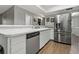 Updated kitchen featuring stainless steel appliances and beautiful wood-look tile flooring at 107 Elm N Sq, Lakeland, FL 33813