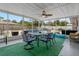 Screened lanai with dining table overlooking the pool and backyard at 107 Elm N Sq, Lakeland, FL 33813