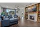 Comfortable living room with a modern sofa, fireplace, and ample natural light at 107 Elm N Sq, Lakeland, FL 33813