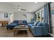 Bright living room with large windows, a ceiling fan, and cozy sectional sofa at 107 Elm N Sq, Lakeland, FL 33813