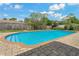 Backyard pool with brick paver deck and mature landscaping at 107 Elm N Sq, Lakeland, FL 33813
