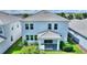 Aerial view of a modern home showcasing a pristine backyard, covered patio, and well-maintained landscaping and roof at 1423 Bunker Dr, Davenport, FL 33896