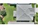 Bird's eye view of a home's roof and manicured backyard, highlighting its layout and meticulously maintained landscape at 1423 Bunker Dr, Davenport, FL 33896